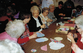 Elderly People Sitting Around The Table