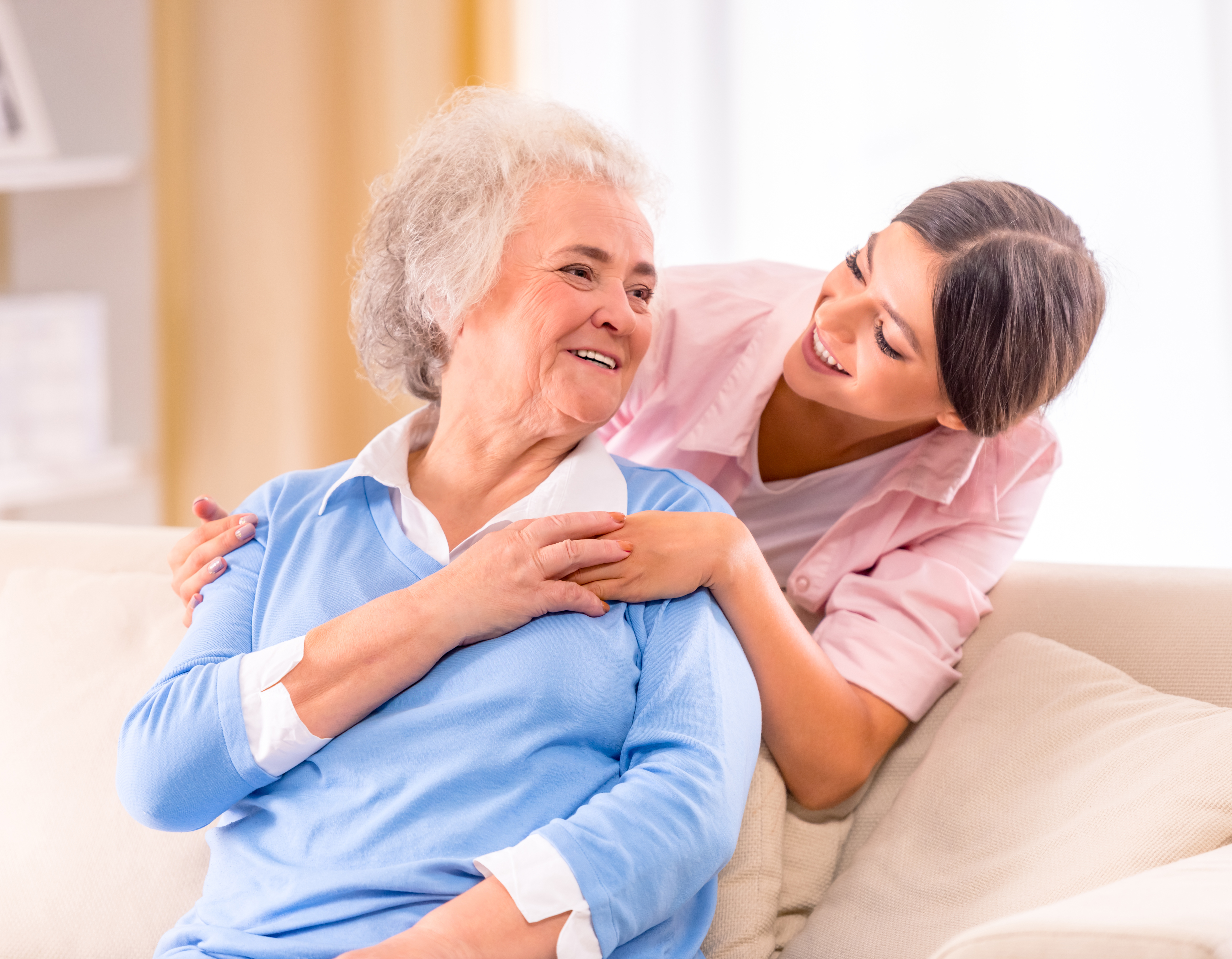 Lady Comforting The Elderly Woman